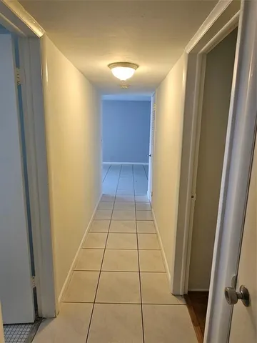 a view of empty room with wooden floor and ceiling fan