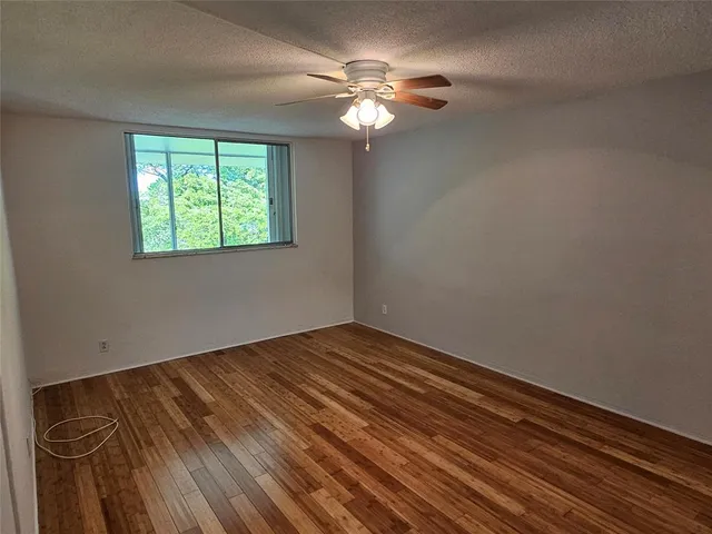 a view of water heater room with wooden floor