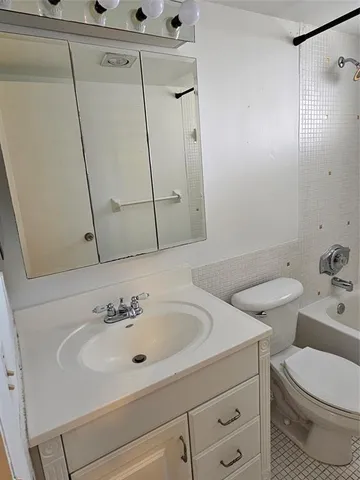 a bathroom with a sink a toilet and mirror
