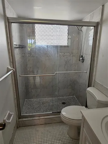a bathroom with a toilet and a shower