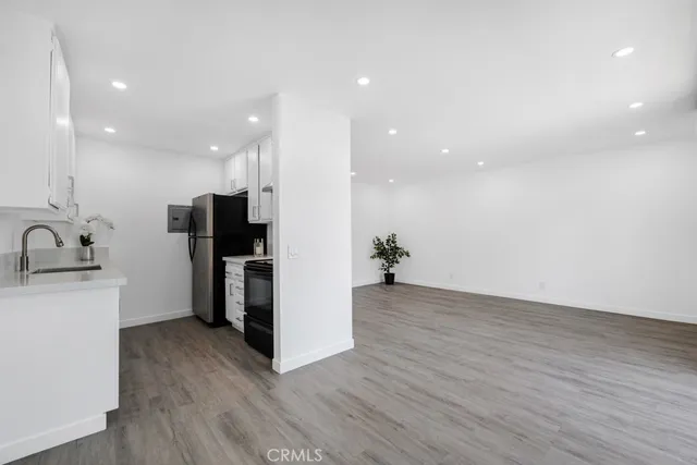 a view of kitchen with stainless steel appliances a refrigerator and a sink