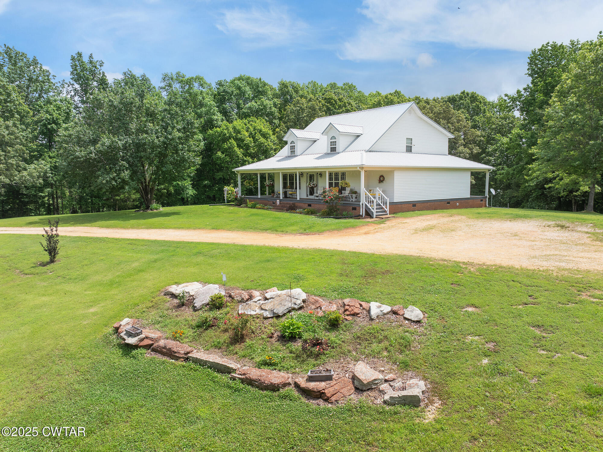 1401 Camper Road Decaturville, TN 38329 - Photo 12 of 40 a front view of a house with a garden and yard