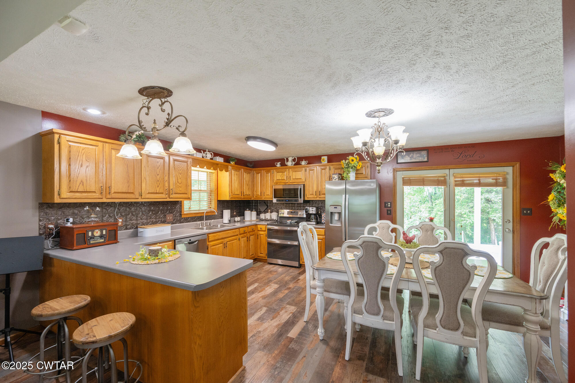 1401 Camper Road Decaturville, TN 38329 - Photo 17 of 40 a kitchen with stainless steel appliances a dining table and chairs