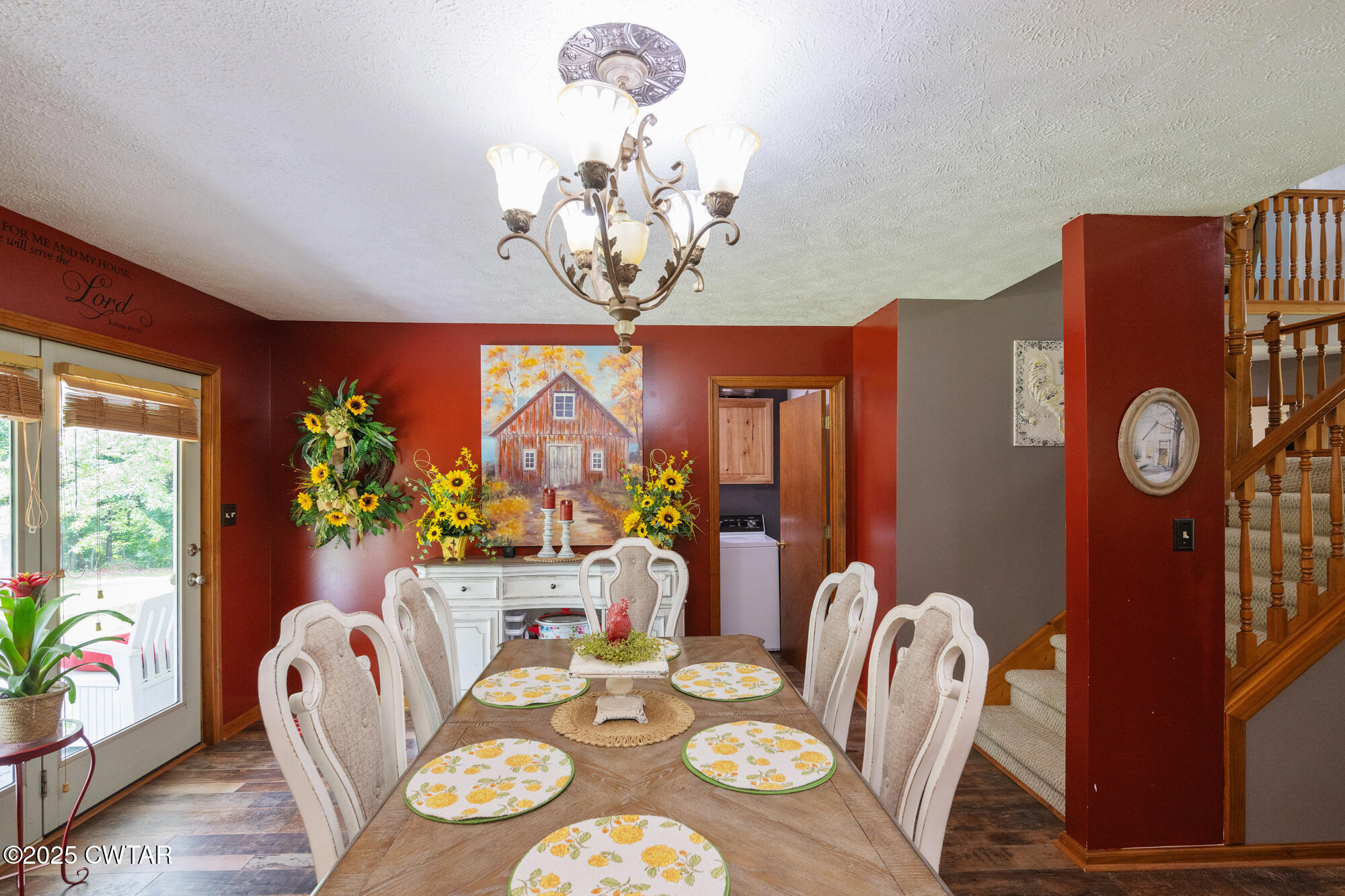 1401 Camper Road Decaturville, TN 38329 - Photo 20 of 40 a view of a dining room with furniture a chandelier and wooden floor