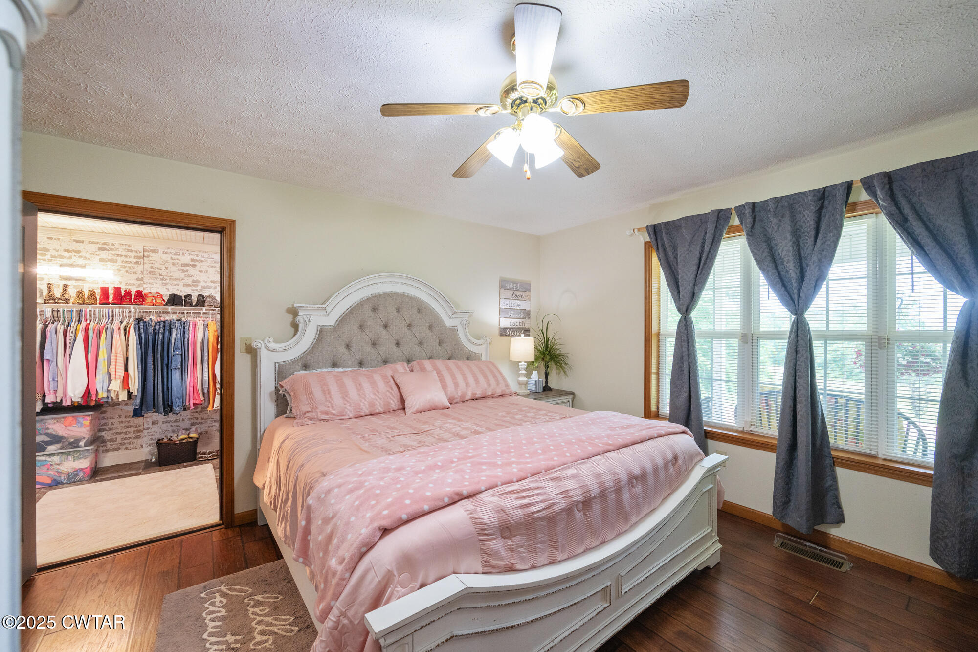1401 Camper Road Decaturville, TN 38329 - Photo 22 of 40 a bedroom with a large bed and a chandelier