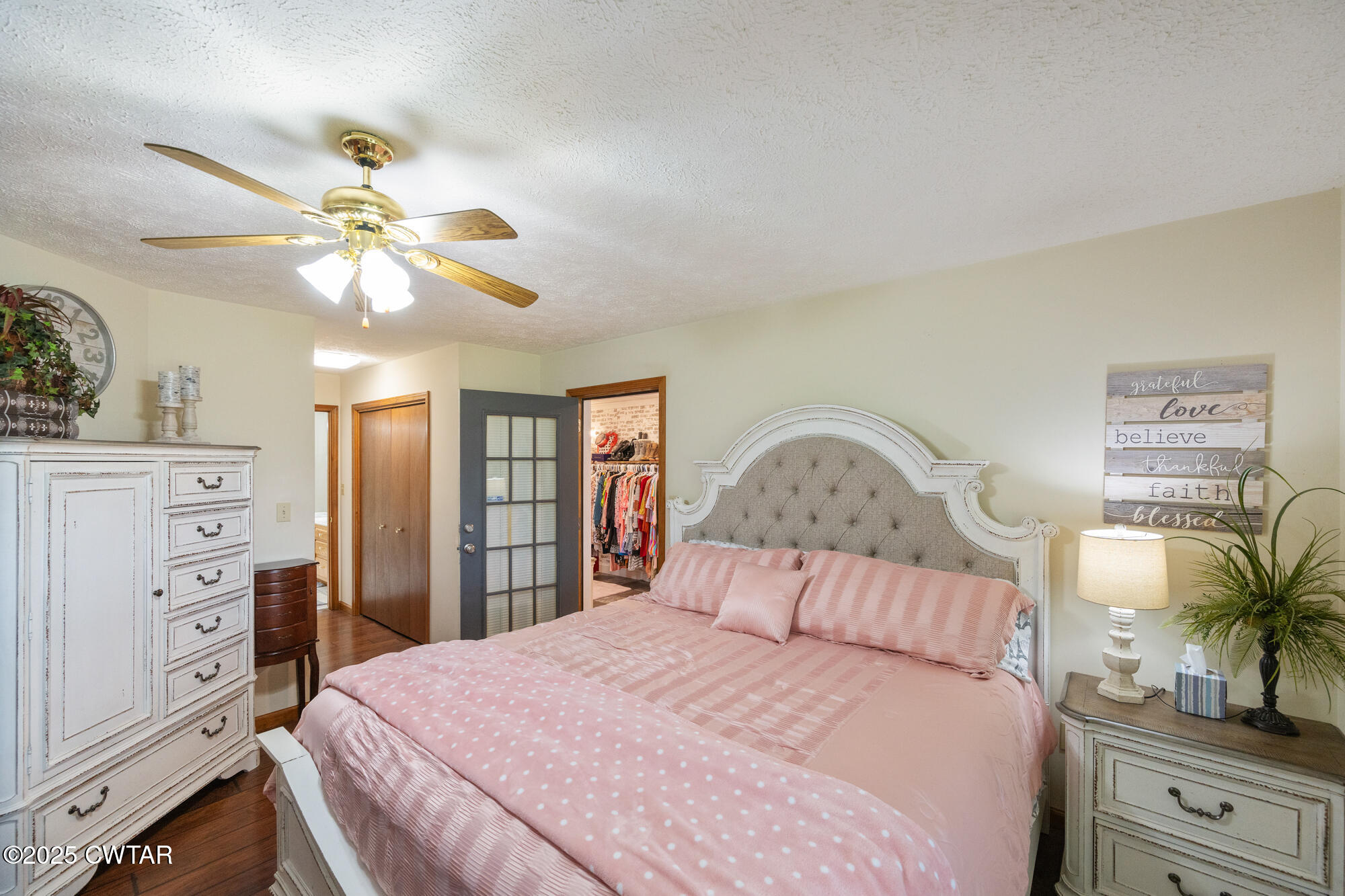 1401 Camper Road Decaturville, TN 38329 - Photo 23 of 40 a bedroom with a bed and a chandelier