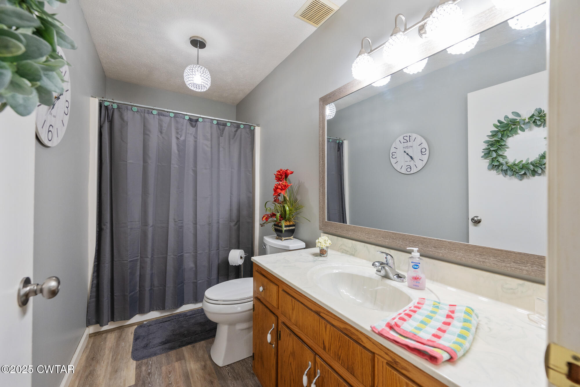 1401 Camper Road Decaturville, TN 38329 - Photo 31 of 40 a bathroom with a sink vanity mirror and toilet