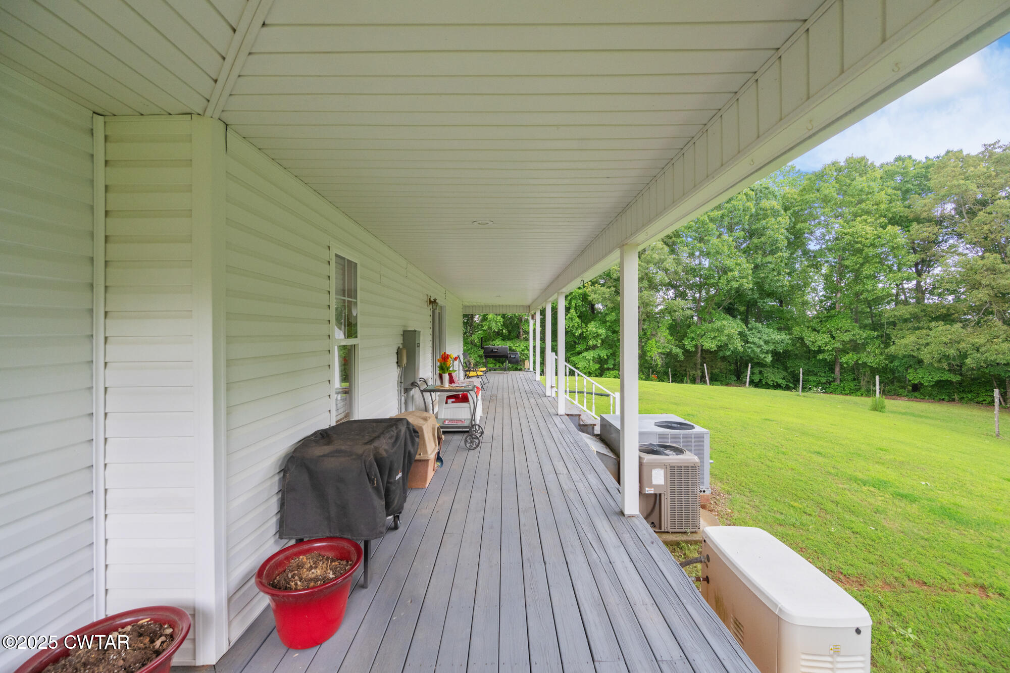 1401 Camper Road Decaturville, TN 38329 - Photo 37 of 40 a view of a deck with a table and chairs next to a yard