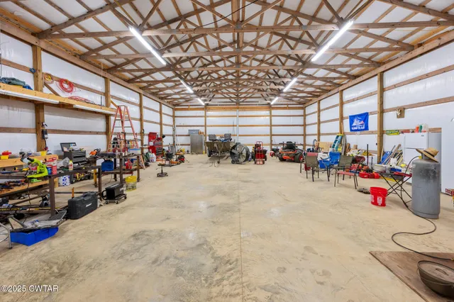 a backyard of a house with plants and large trees