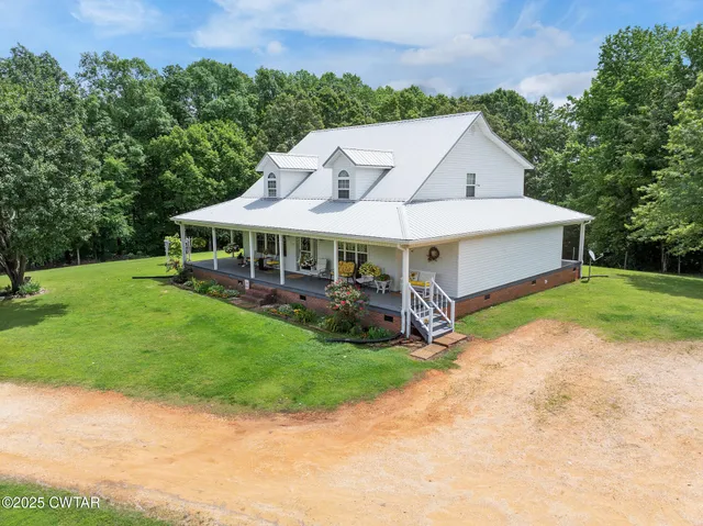 a view of a house with a yard and sitting area
