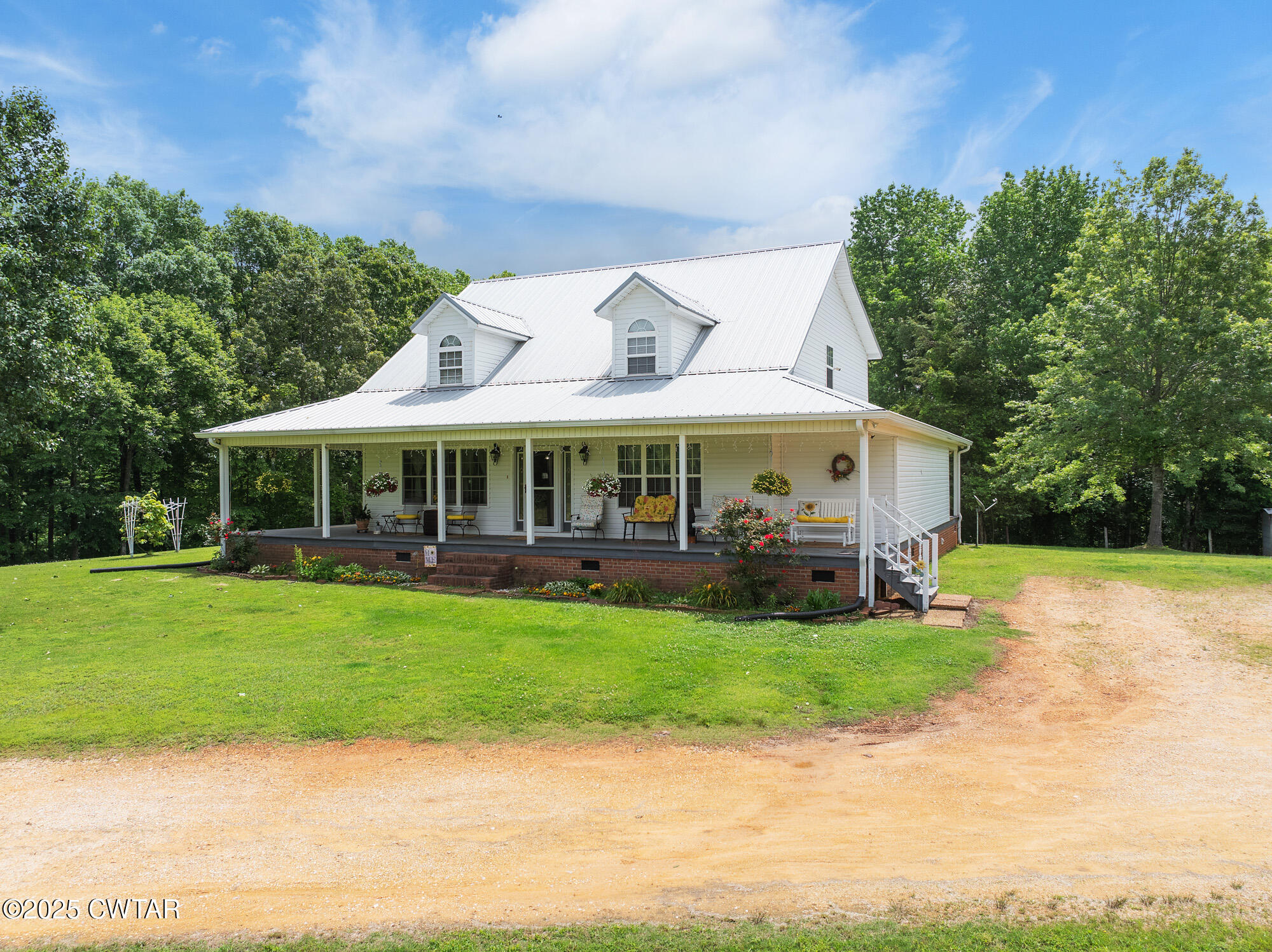 1401 Camper Road Decaturville, TN 38329 - Photo 5 of 40 a front view of a house with garden
