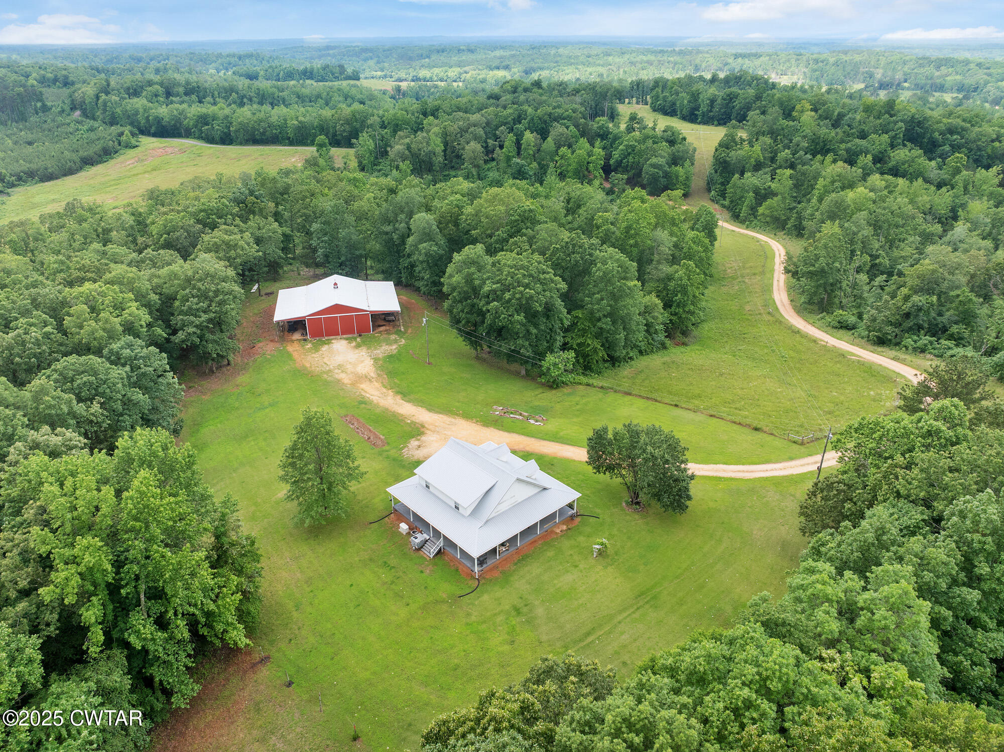 1401 Camper Road Decaturville, TN 38329 - Photo 8 of 40 an aerial view of a house with pool big yard and large trees