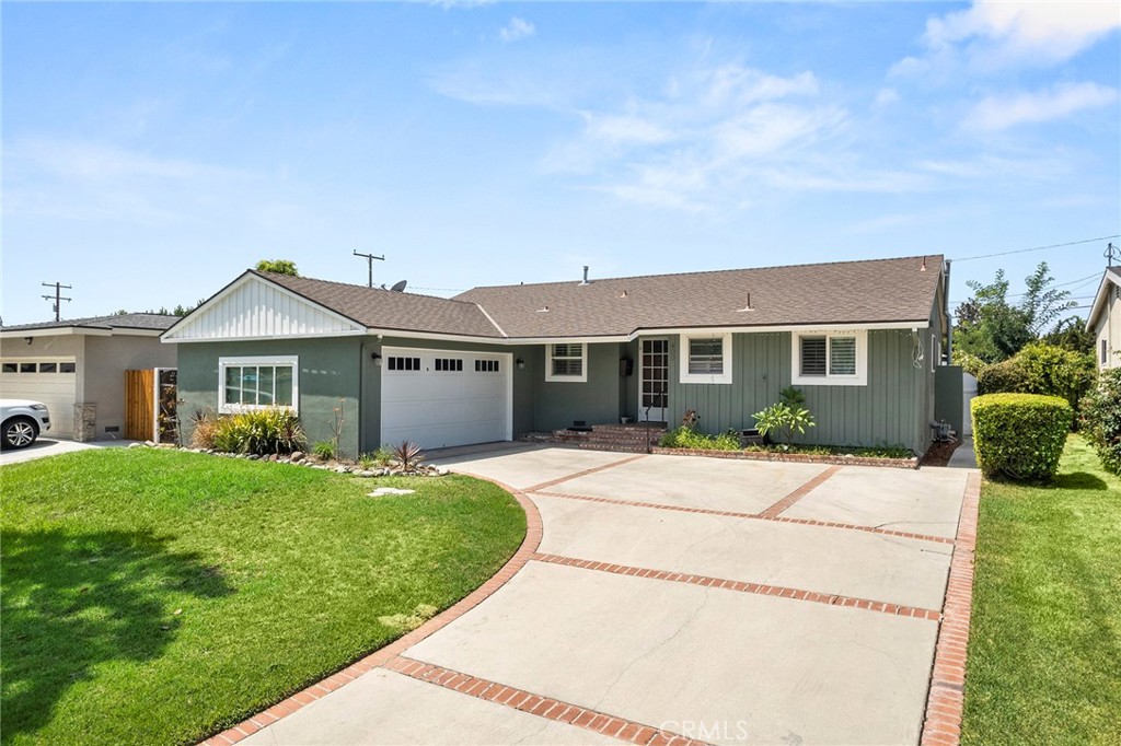 a front view of a house with a garden and porch