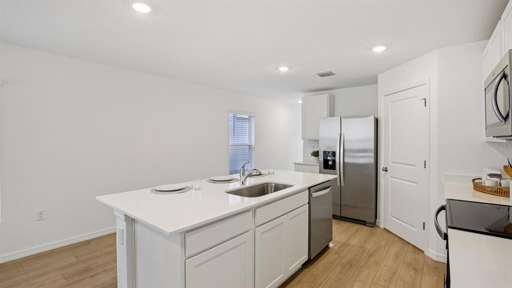 1060 Spotted Egret Loop Ruskin, FL 33570 - Photo 12 of 26 a kitchen with a sink cabinets and refrigerator