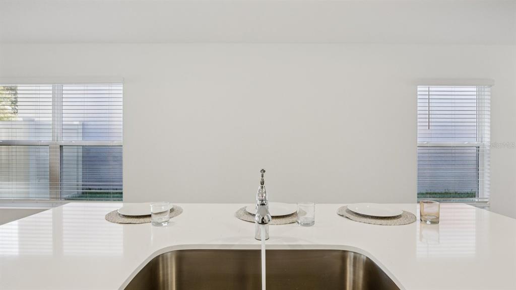 1060 Spotted Egret Loop Ruskin, FL 33570 - Photo 13 of 26 a bathroom with a granite countertop sink and a mirror