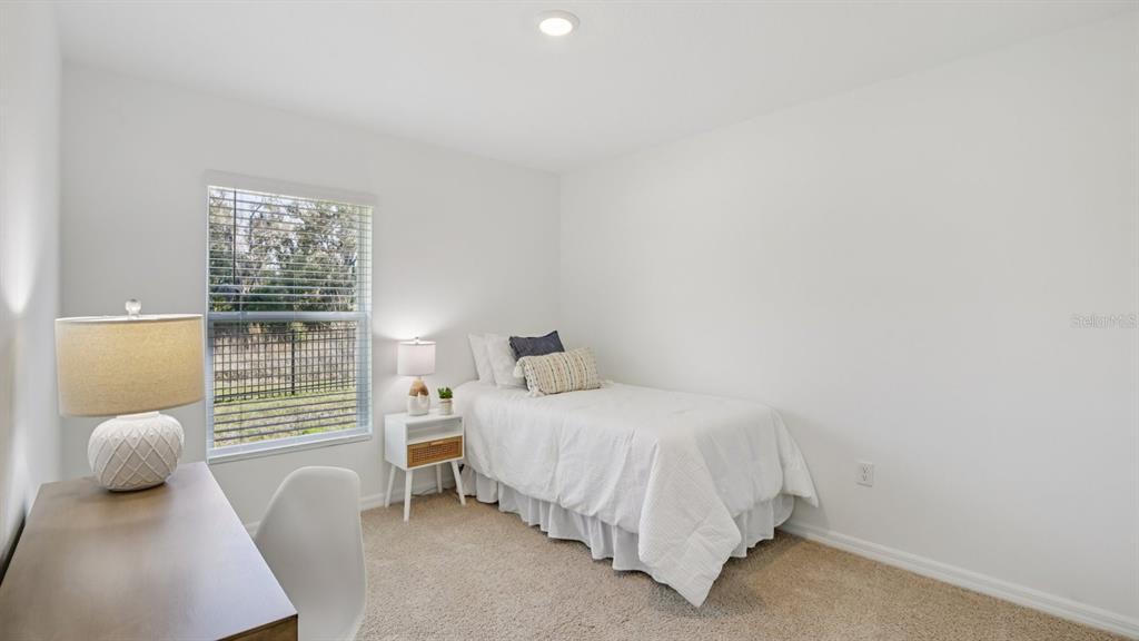 1060 Spotted Egret Loop Ruskin, FL 33570 - Photo 22 of 26 a bedroom with a bed and chair