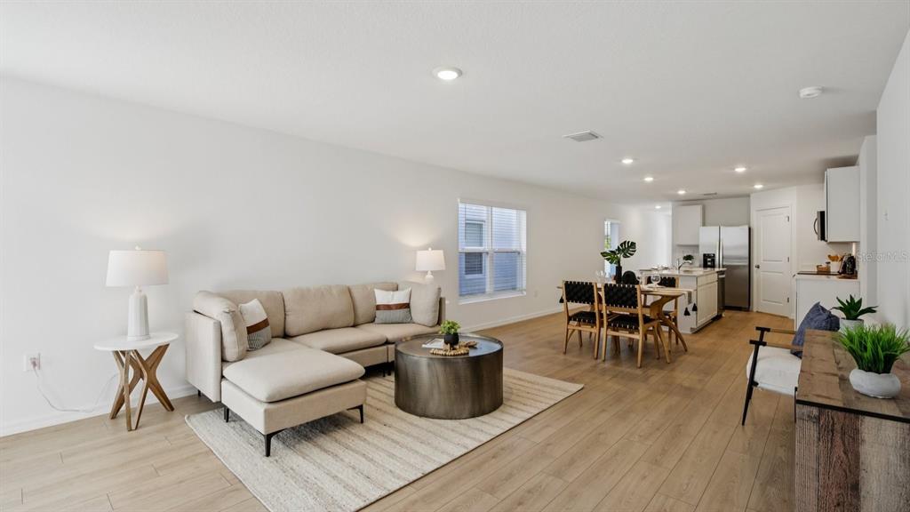 1060 Spotted Egret Loop Ruskin, FL 33570 - Photo 4 of 26 a living room with furniture a wooden floor and a view