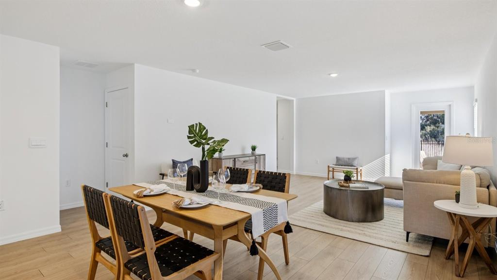 1060 Spotted Egret Loop Ruskin, FL 33570 - Photo 8 of 26 a dining room with furniture and wooden floor