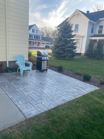a view of a house with a yard and sitting area
