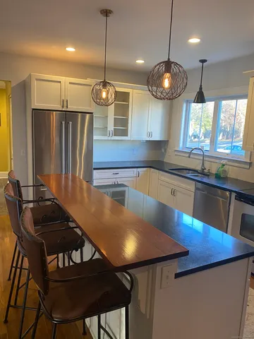 a large kitchen with a table and chairs