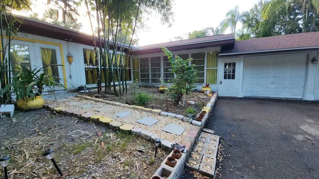 a front view of a house with garden
