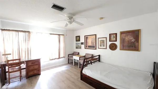 a bedroom with a bed and dresser with mirror