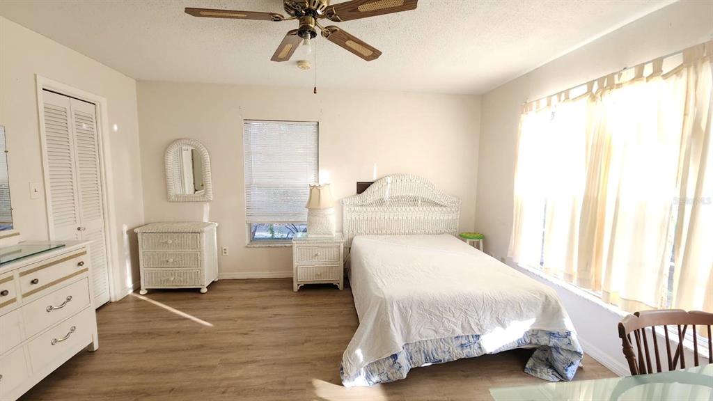 2405 Neptune Road Kissimmee, FL 34744 - Photo 13 of 17 a bedroom with a bed and dresser with mirror