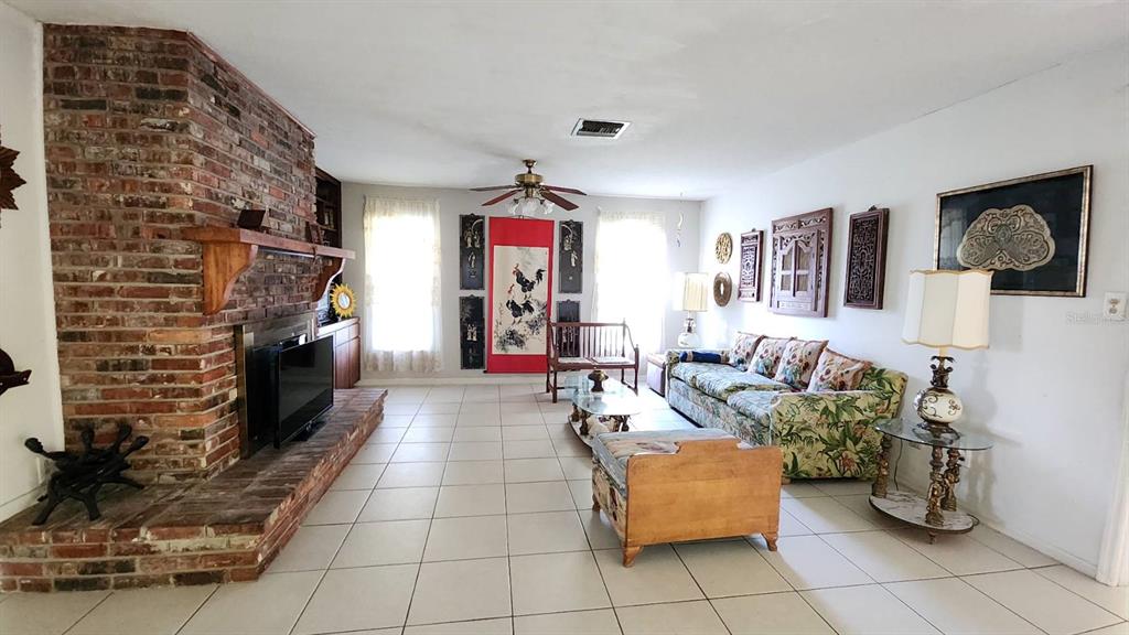2405 Neptune Road Kissimmee, FL 34744 - Photo 16 of 17 a living room with furniture and a fireplace