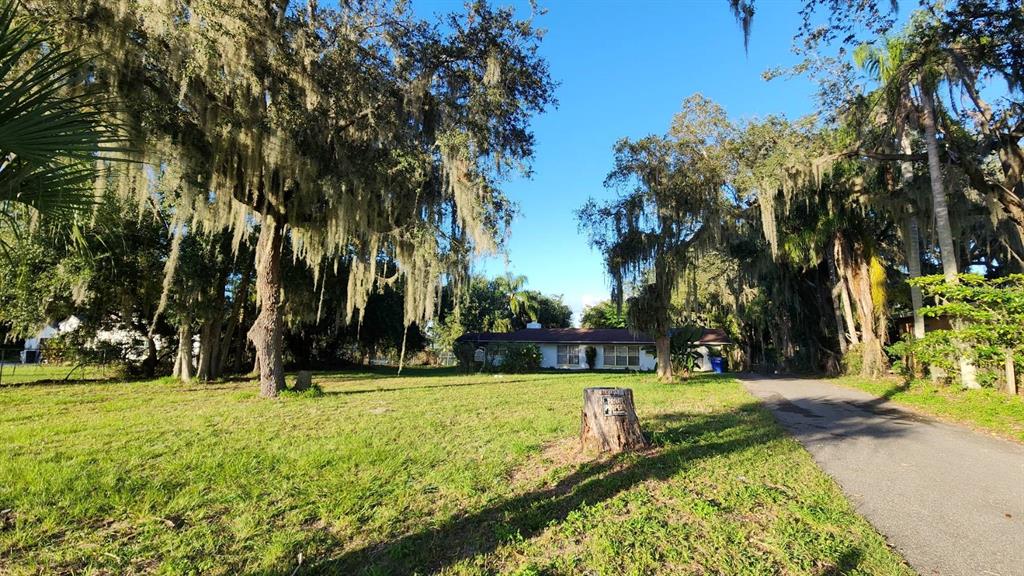 2405 Neptune Road Kissimmee, FL 34744 - Photo 3 of 17 a view of swimming pool with lawn chairs under an umbrella