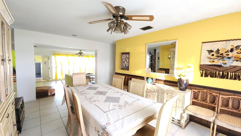 2405 Neptune Road Kissimmee, FL 34744 - Photo 4 of 17 a view of a dining room with furniture and a large window