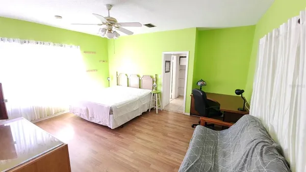 a bedroom with a bed window and couch