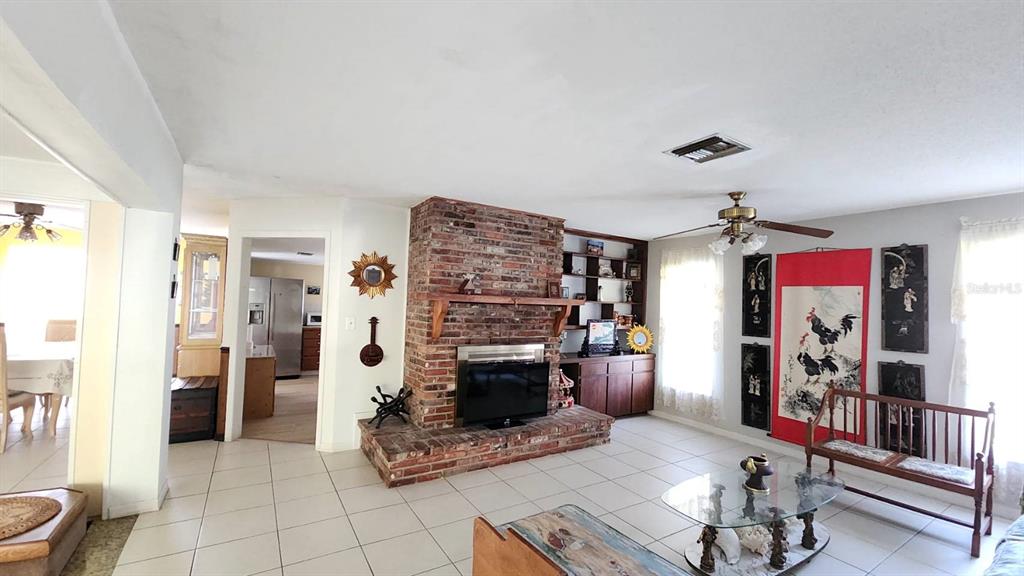 2405 Neptune Road Kissimmee, FL 34744 - Photo 6 of 17 a living room with furniture and a fireplace