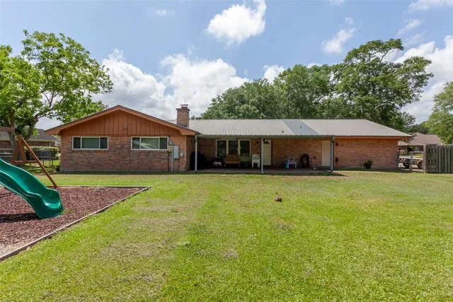 a front view of house with yard outdoor seating and barbeque oven