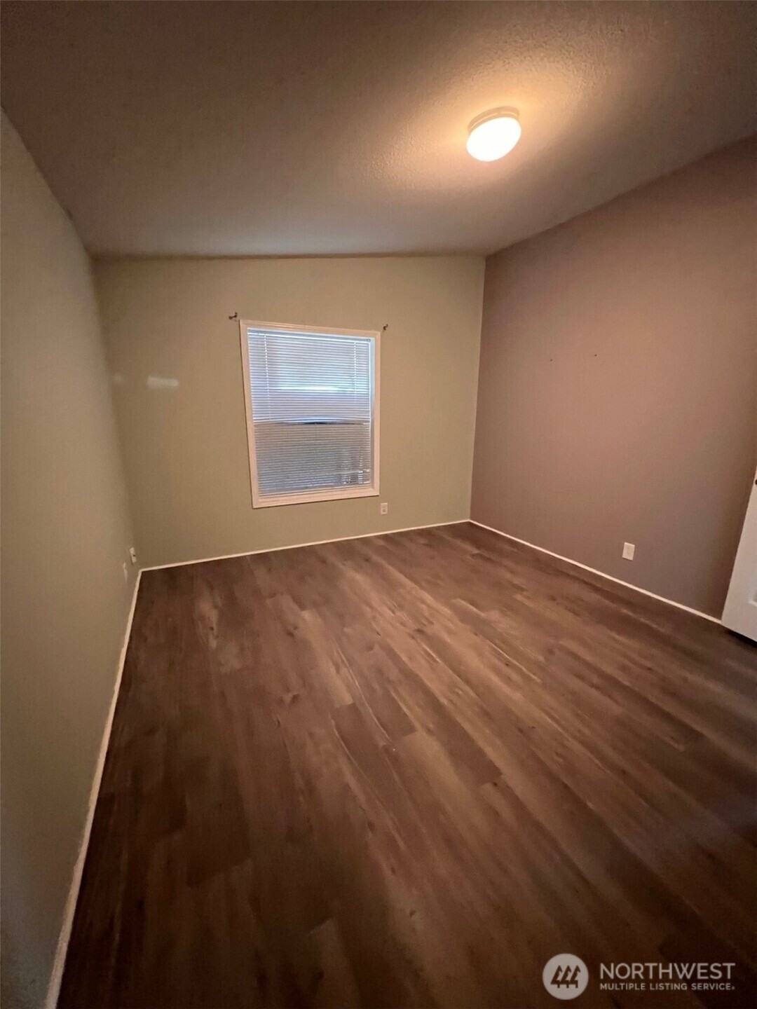 4731 East Rasor Road Belfair, WA 98528 - Photo 14 of 21 en empty room with wooden floor and windows