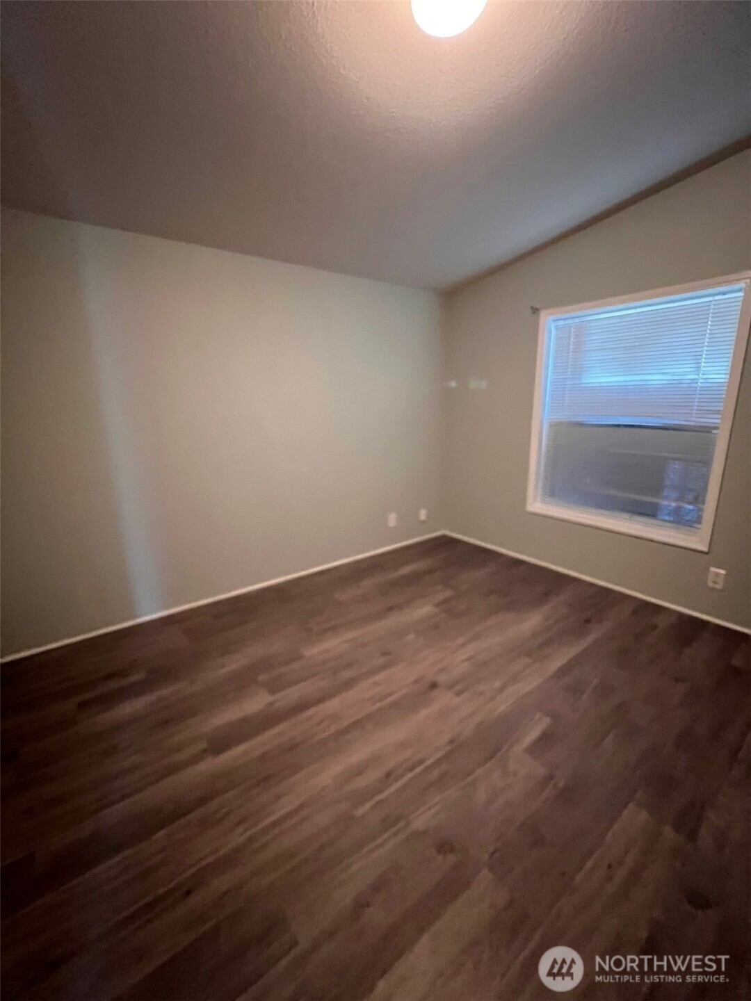 4731 East Rasor Road Belfair, WA 98528 - Photo 15 of 21 a view of an empty room with wooden floor and closet