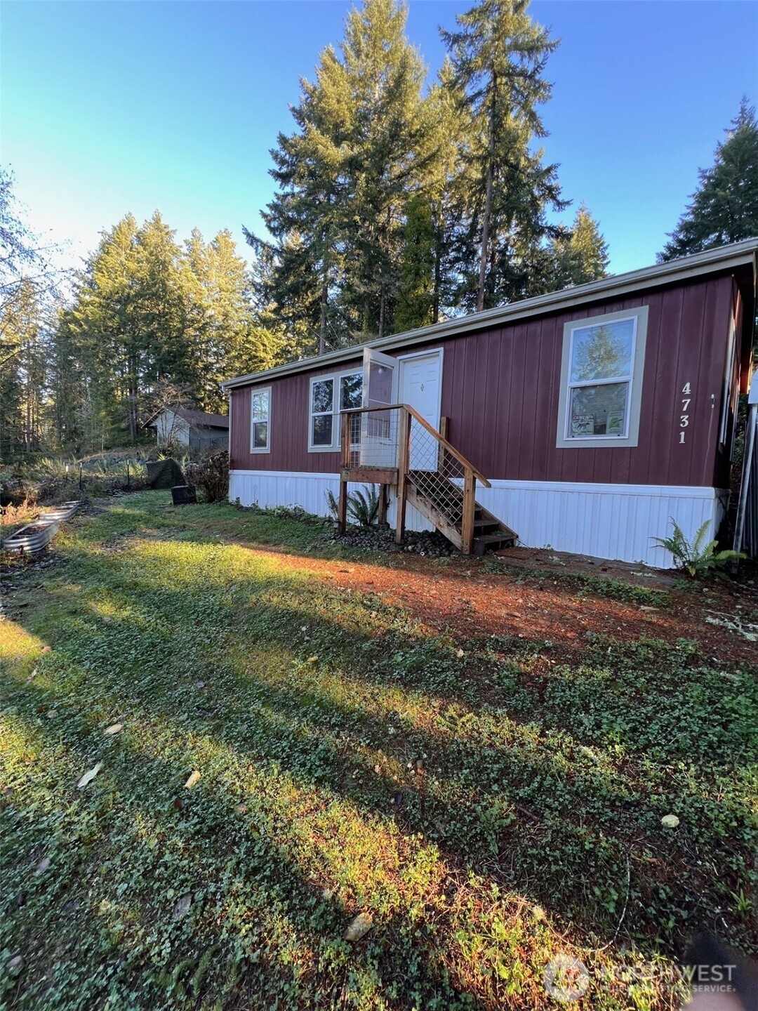 4731 East Rasor Road Belfair, WA 98528 - Photo 2 of 21 a view of a house with a yard