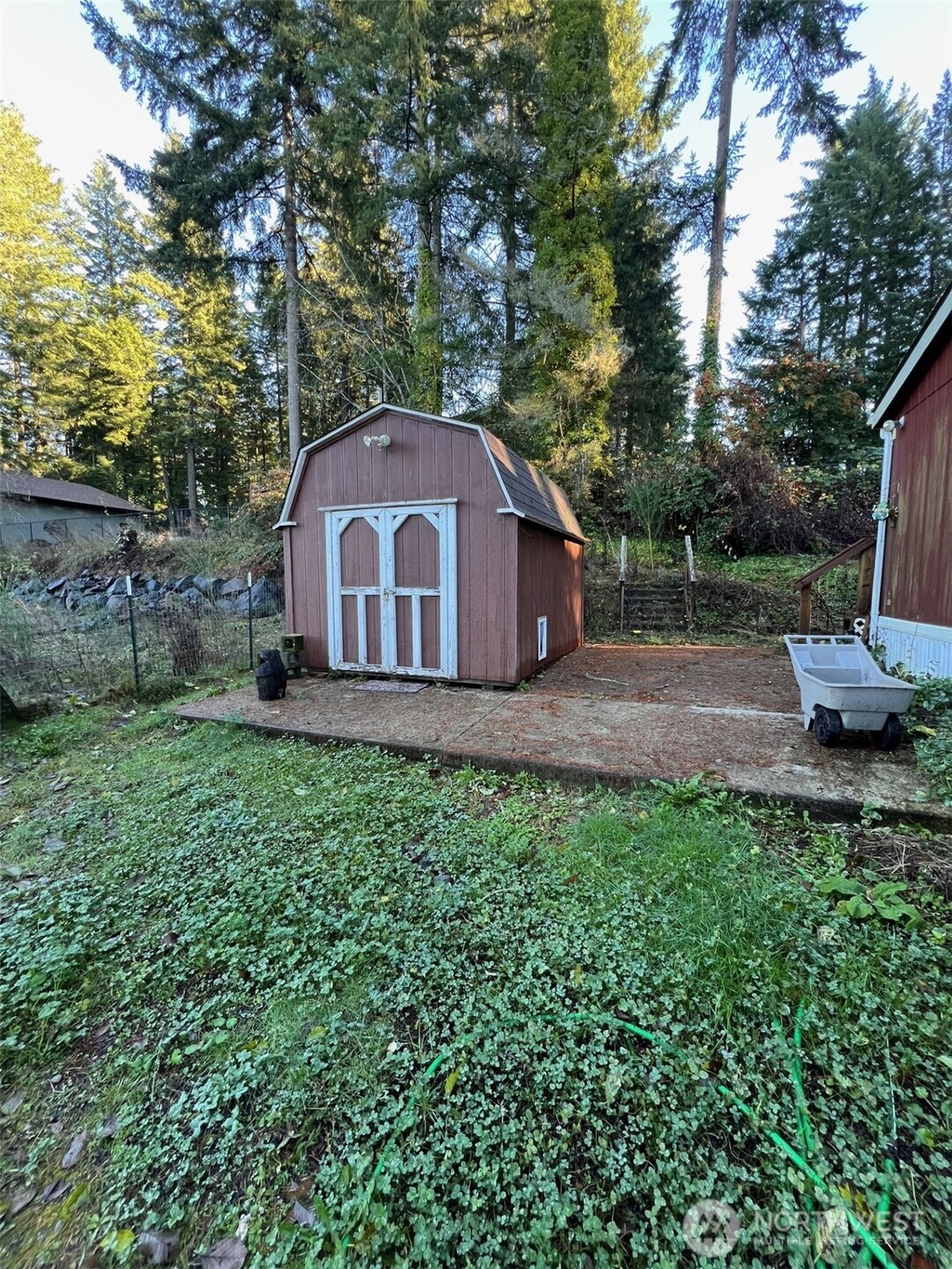 4731 East Rasor Road Belfair, WA 98528 - Photo 4 of 21 a front view of a house with a garden