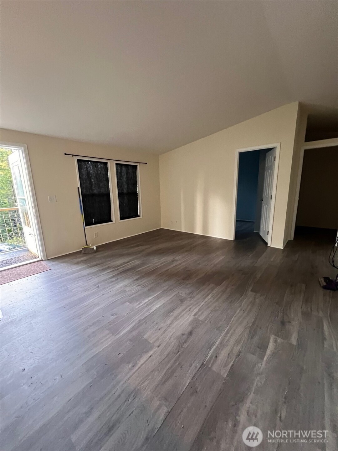 4731 East Rasor Road Belfair, WA 98528 - Photo 8 of 21 a view of an empty room with wooden floor and a window