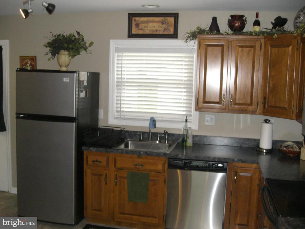 204 North Elm Street Lititz, PA 17543 - Photo 6 of 11 a kitchen with granite countertop a refrigerator and a sink