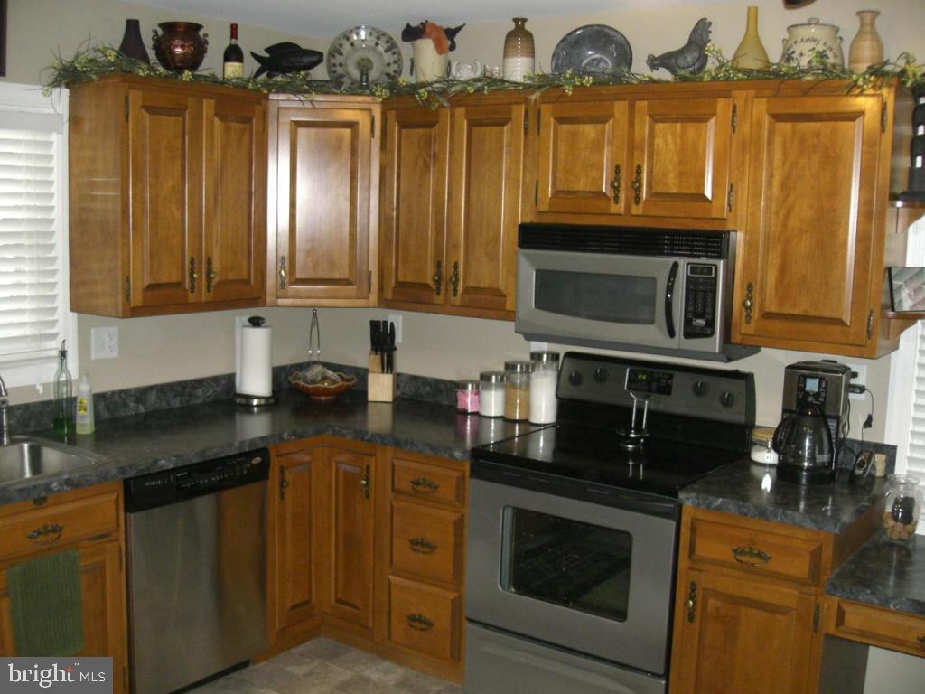 204 North Elm Street Lititz, PA 17543 - Photo 7 of 11 a kitchen with stainless steel appliances granite countertop a stove a sink and a microwave