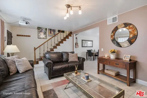 a living room with furniture a rug and a window
