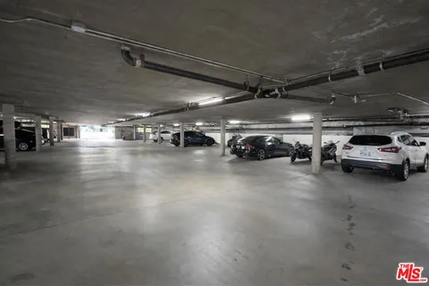 a view of parking garage with cars parked