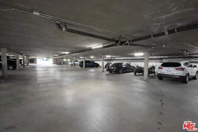 a view of parking garage with cars parked