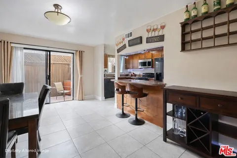 a view of a dining room with furniture and a chandelier