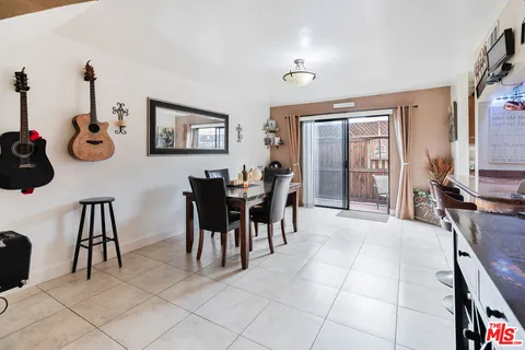 a dining room with furniture and a window
