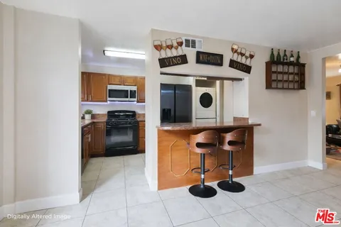 a kitchen with a stove a microwave and a dining table
