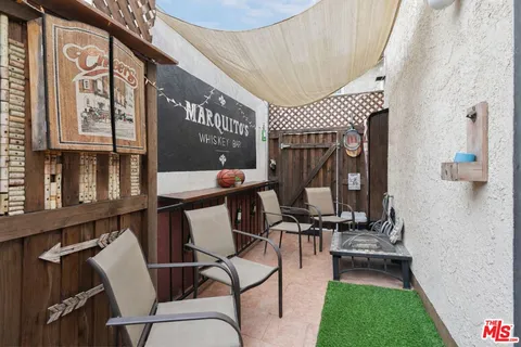 a view of a chairs and table in a patio