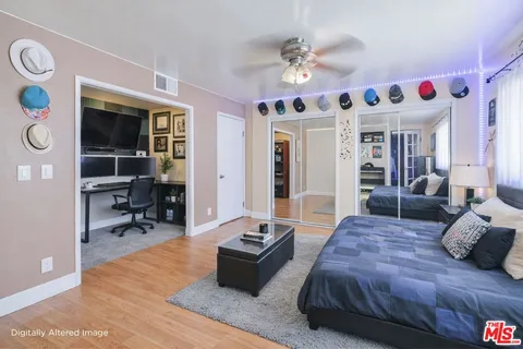 a spacious bedroom with a bed and a table in it