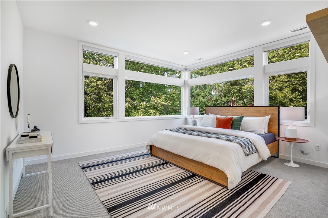 3217 East Spring Street Seattle, WA 98122 - Photo 13 of 33 a bedroom with a bed and a large window