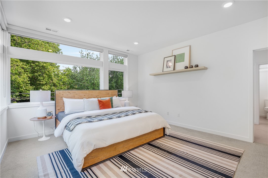 3217 East Spring Street Seattle, WA 98122 - Photo 14 of 33 a bedroom with a bed and a large window